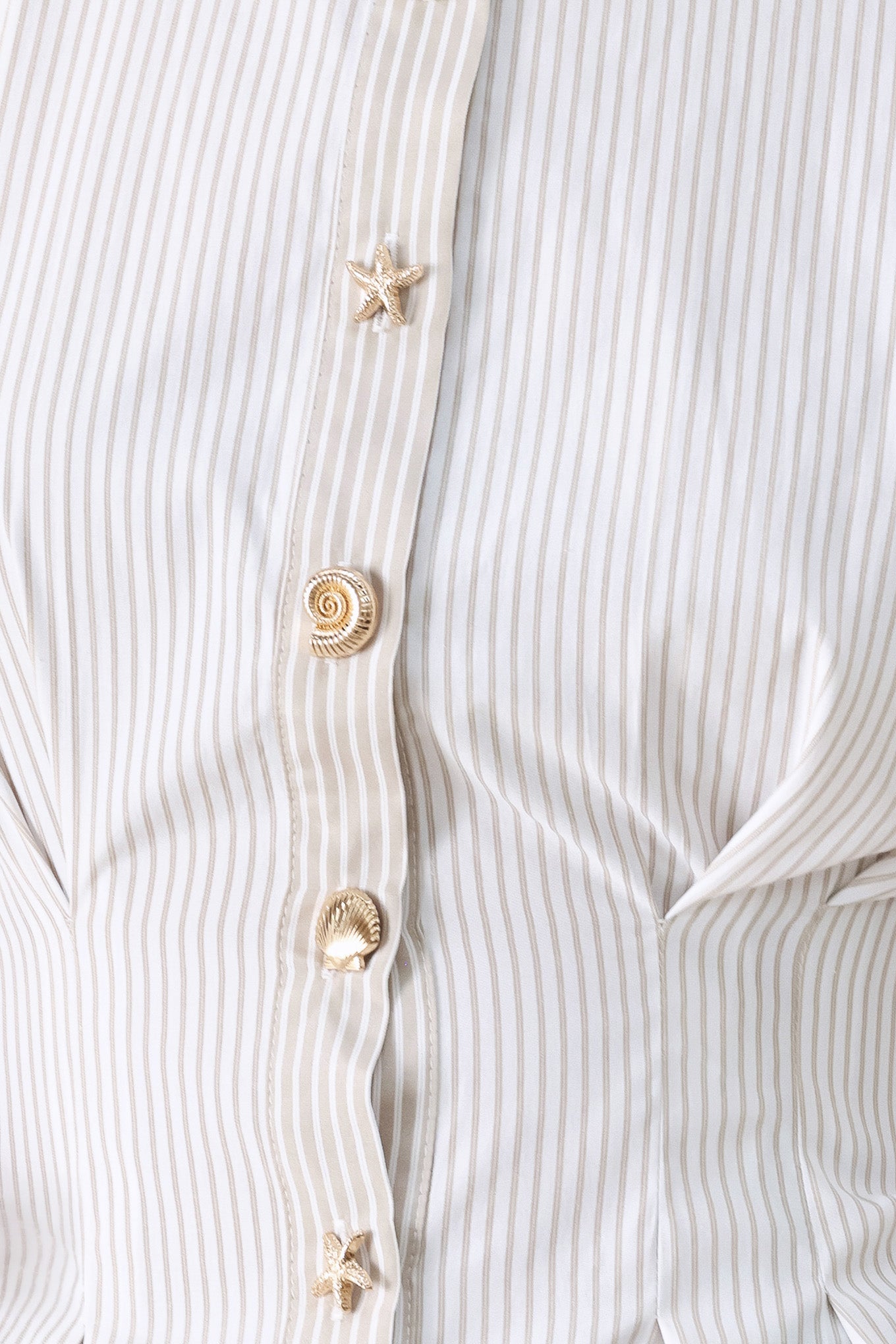 Close up of a taupe and white striped woven top featuring short puff sleeve, front button down, corset waist and peplum | FREEMARKET