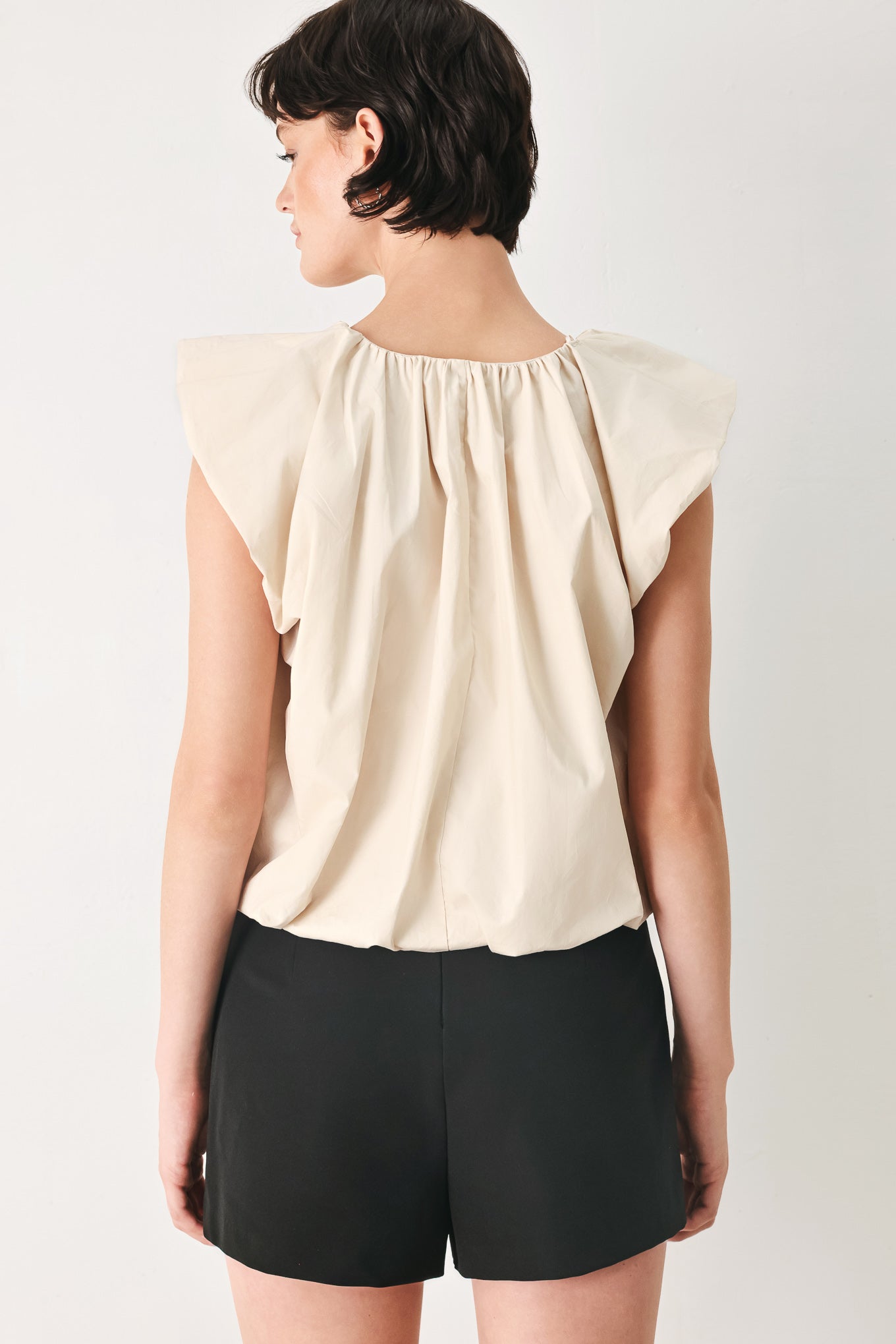 Woman wearing n ivory blouse top with V neckline and bubble sleeve and waist  | FREEMARKET