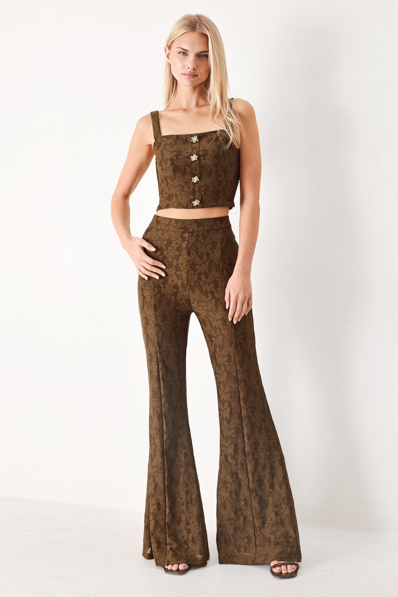 Woman wearing a brown crop top and pants set with front button detail and smocked back bodice | FREEMARKET