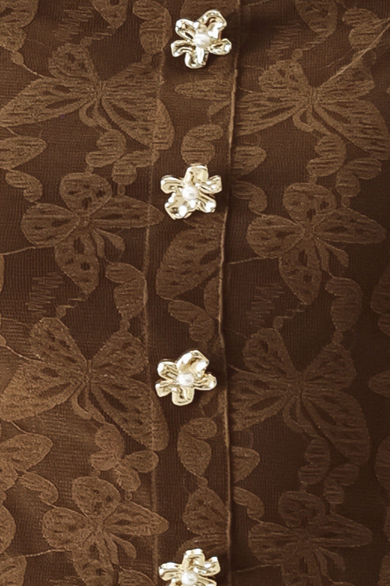 Close-up of a brown lace garment with floral buttons | FREEMARKET