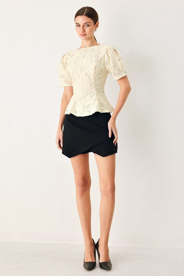 Woman wearing a white lace jacquard top featuring round neckline, short sleeve, peplum and V back with zipper closure | FREEMARKET