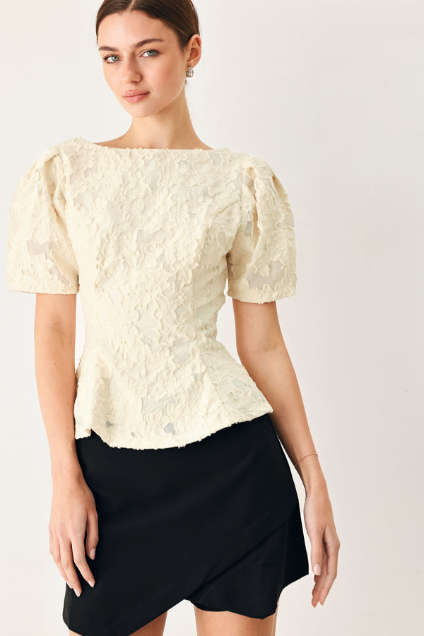 Woman wearing a white lace jacquard top featuring round neckline, short sleeve, peplum and V back with zipper closure | FREEMARKET