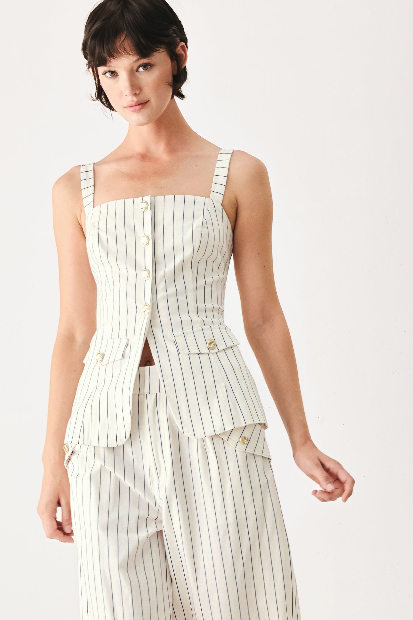Woman wearing a top with navy pinstripes and gold buttons | FREEMARKET