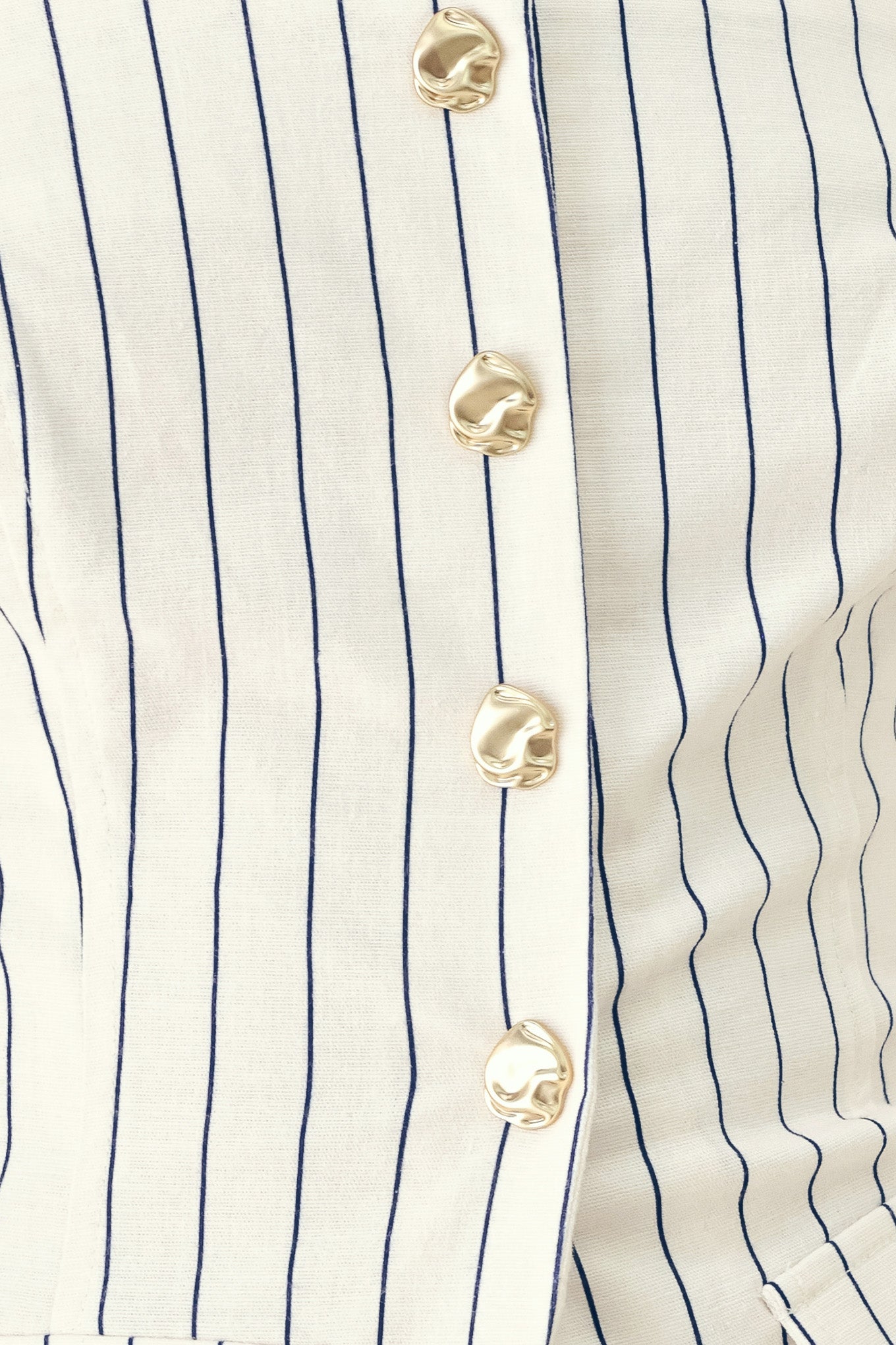 Woman wearing a top with navy pinstripes and gold buttons | FREEMARKET