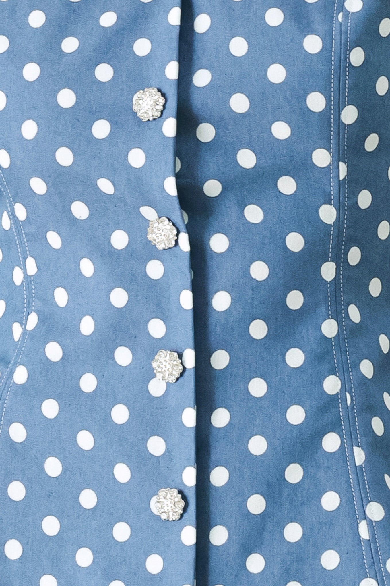 Close up of a blue polka dot top featuring sweetheart neckline, sleeveless, front button detail, peplum and back zipper closure | FREEMARKET