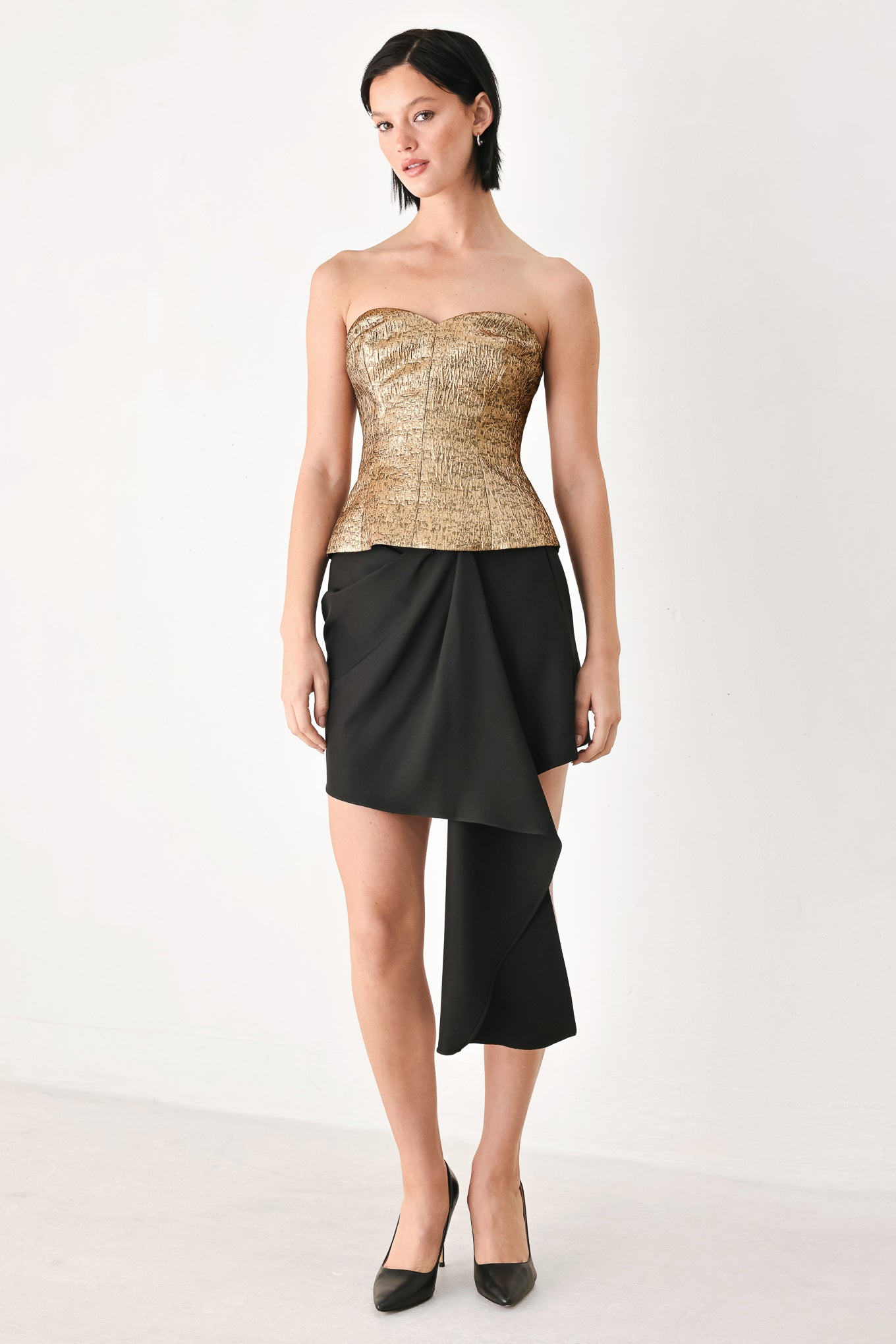 A woman wearing a metallic gold strapless tube top with sweetheart neckline and back zipper | FREEMARKET