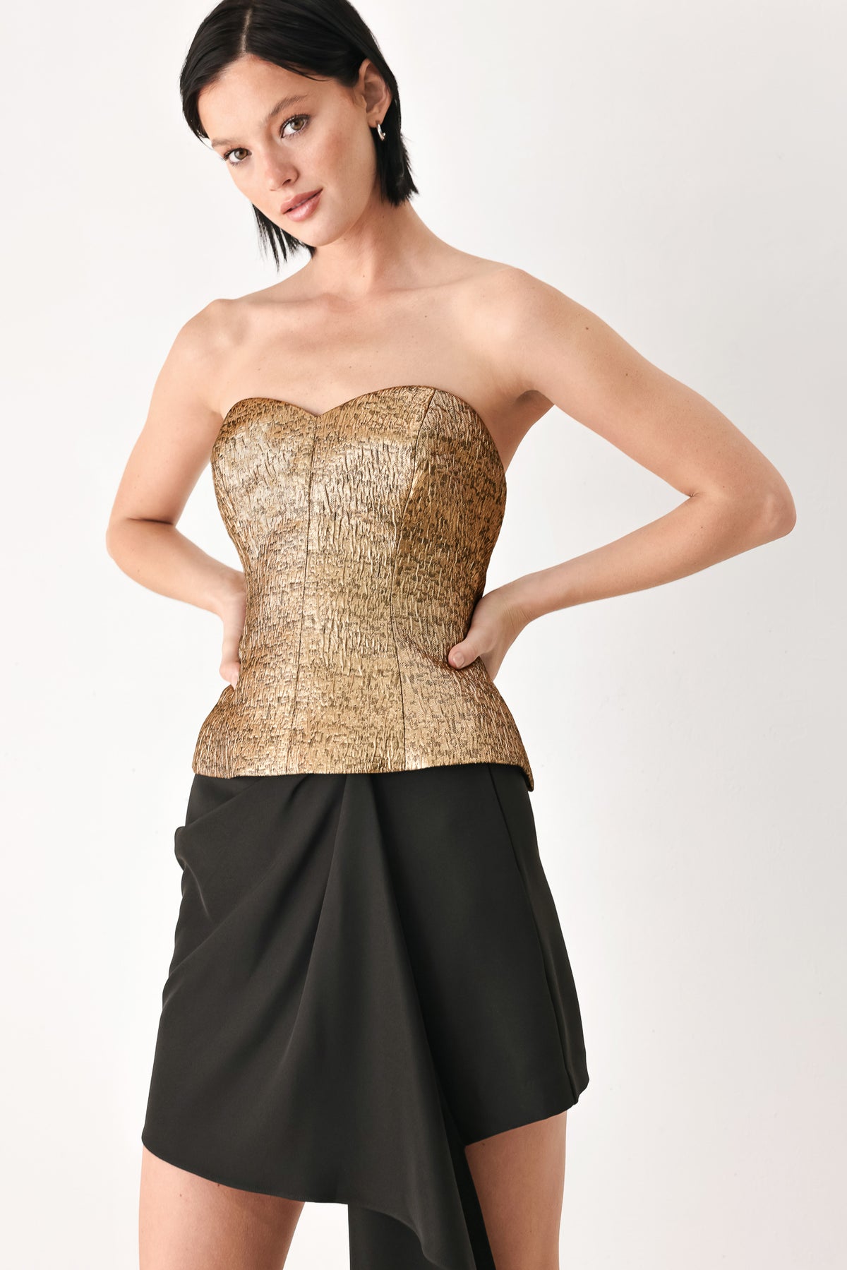 A woman wearing a metallic gold strapless tube top with sweetheart neckline and back zipper | FREEMARKET