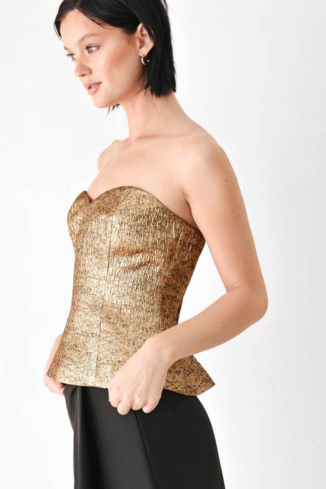 A woman wearing a metallic gold strapless tube top with sweetheart neckline and back zipper | FREEMARKET