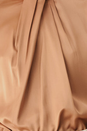 A woman wearing a bronze long-sleeve blouse with a gathered high neck and voluminous sleeves | FREEMARKET