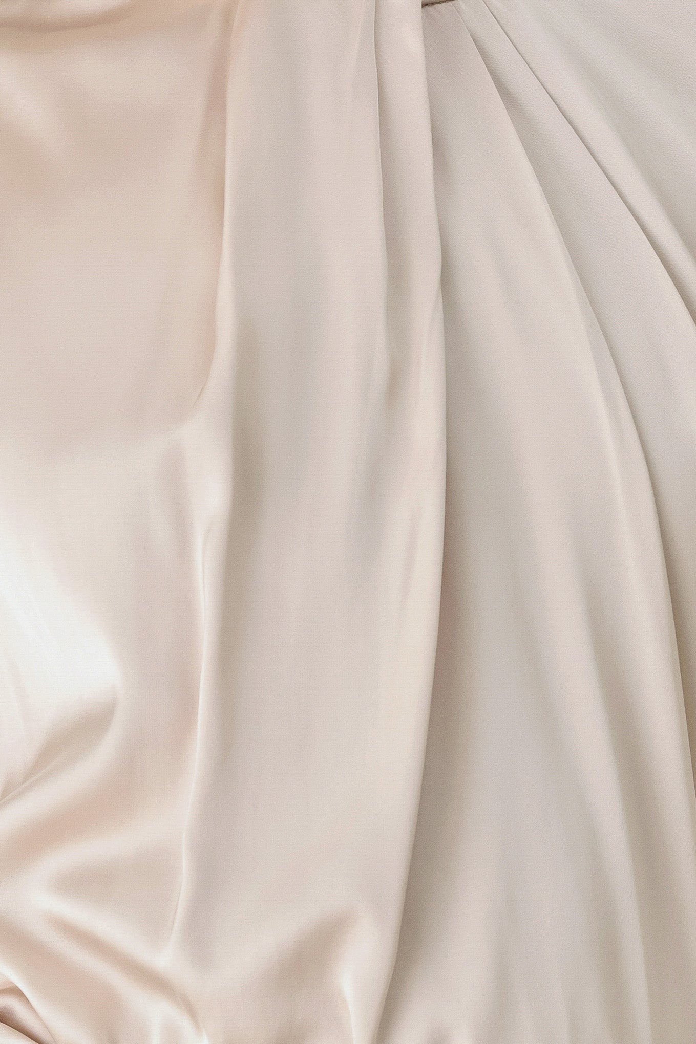 A woman wearing a champagne ivory long-sleeve blouse with a gathered high neck and voluminous sleeves | FREEMARKET