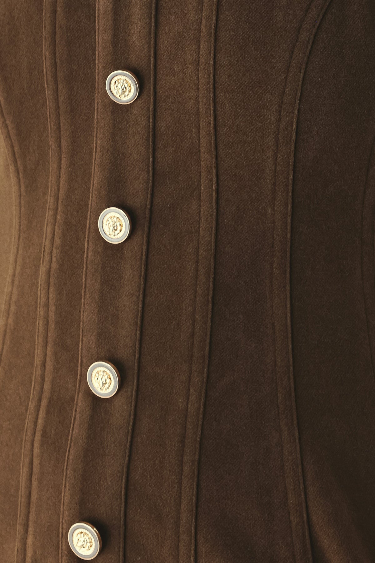 A woman wearing a brown sleeveless vest with a square neckline, front button closure, and vertical seam detailing | FREEMARKET
