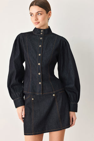 Woman wearing lightweight dark denim top with high neckline, long sleeve, front button down and peplum | FREEMARKET