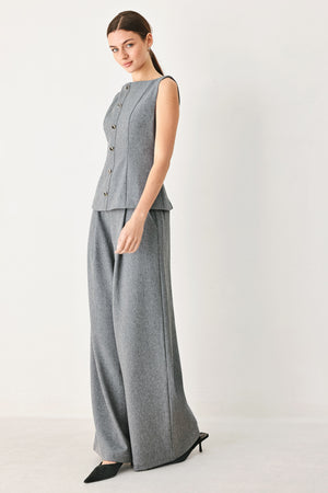 A woman wearing a gray sleeveless button-front top featuring wide neckline | FREEMARKET