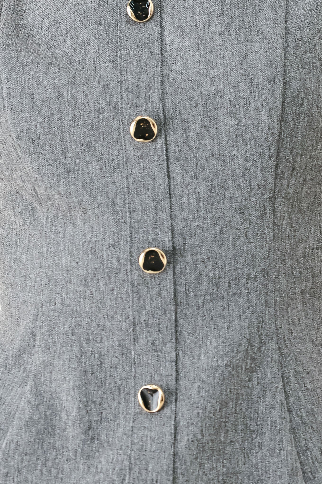 A woman wearing a gray sleeveless button-front top featuring wide neckline | FREEMARKET