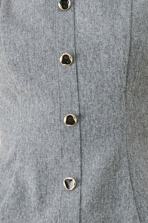 A woman wearing a gray sleeveless button-front top featuring wide neckline | FREEMARKET