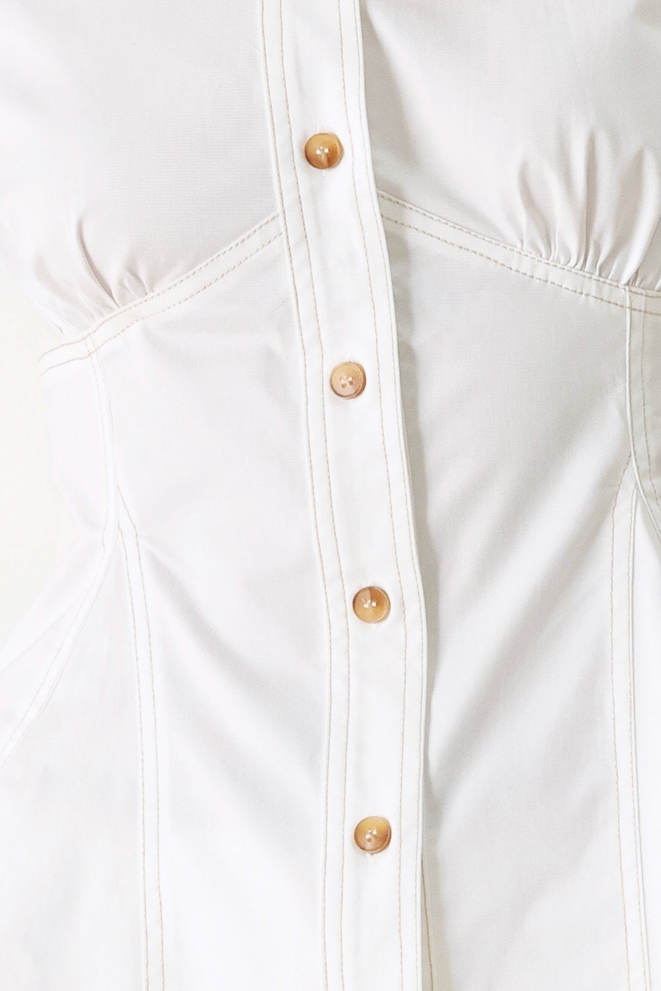 Close up of a white  top with front button closure, short sleeve and peplum | FREEMARKET