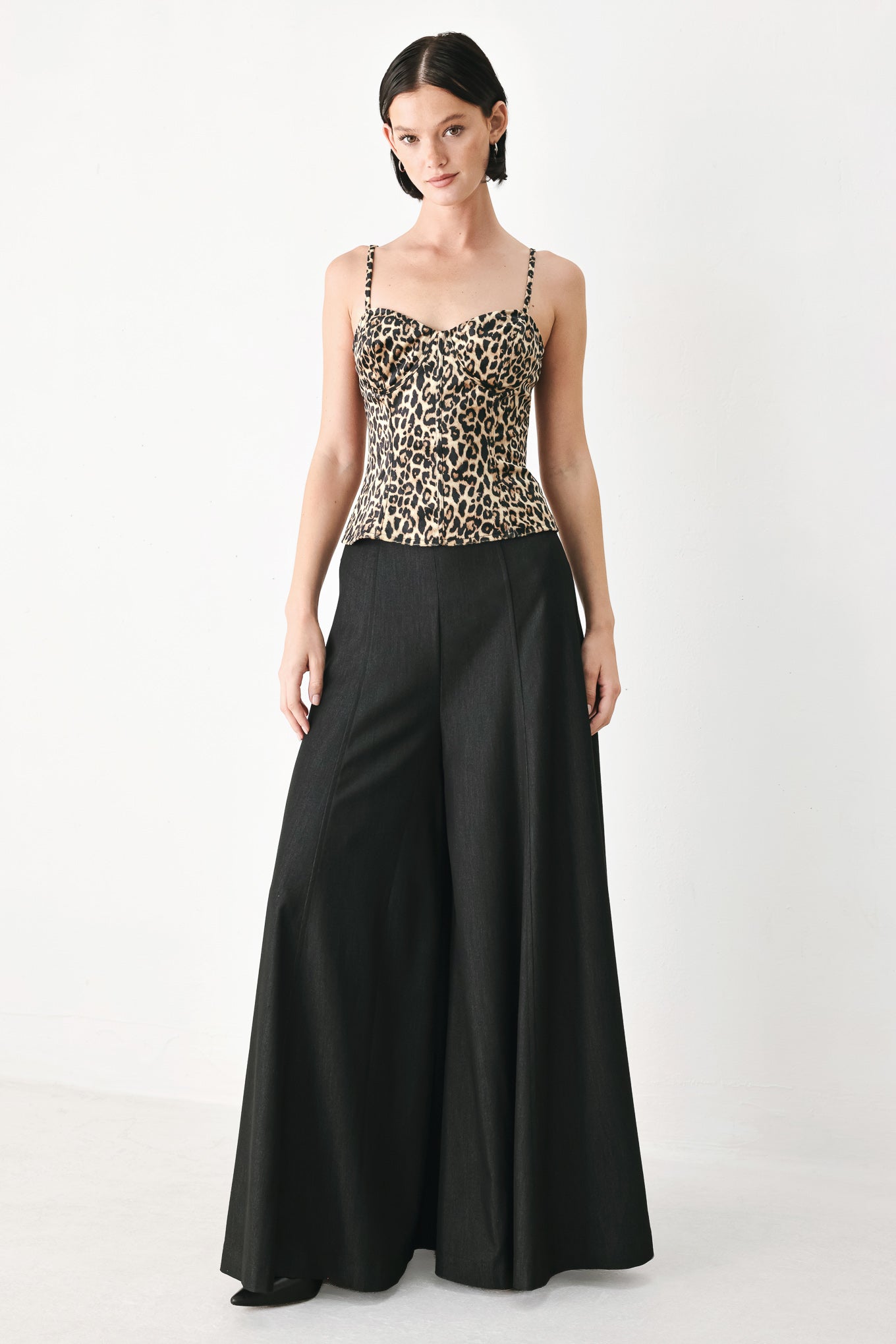 A woman modeling a leopard-print camisole top with thin straps and a structured corset-style bodice | FREEMARKET
