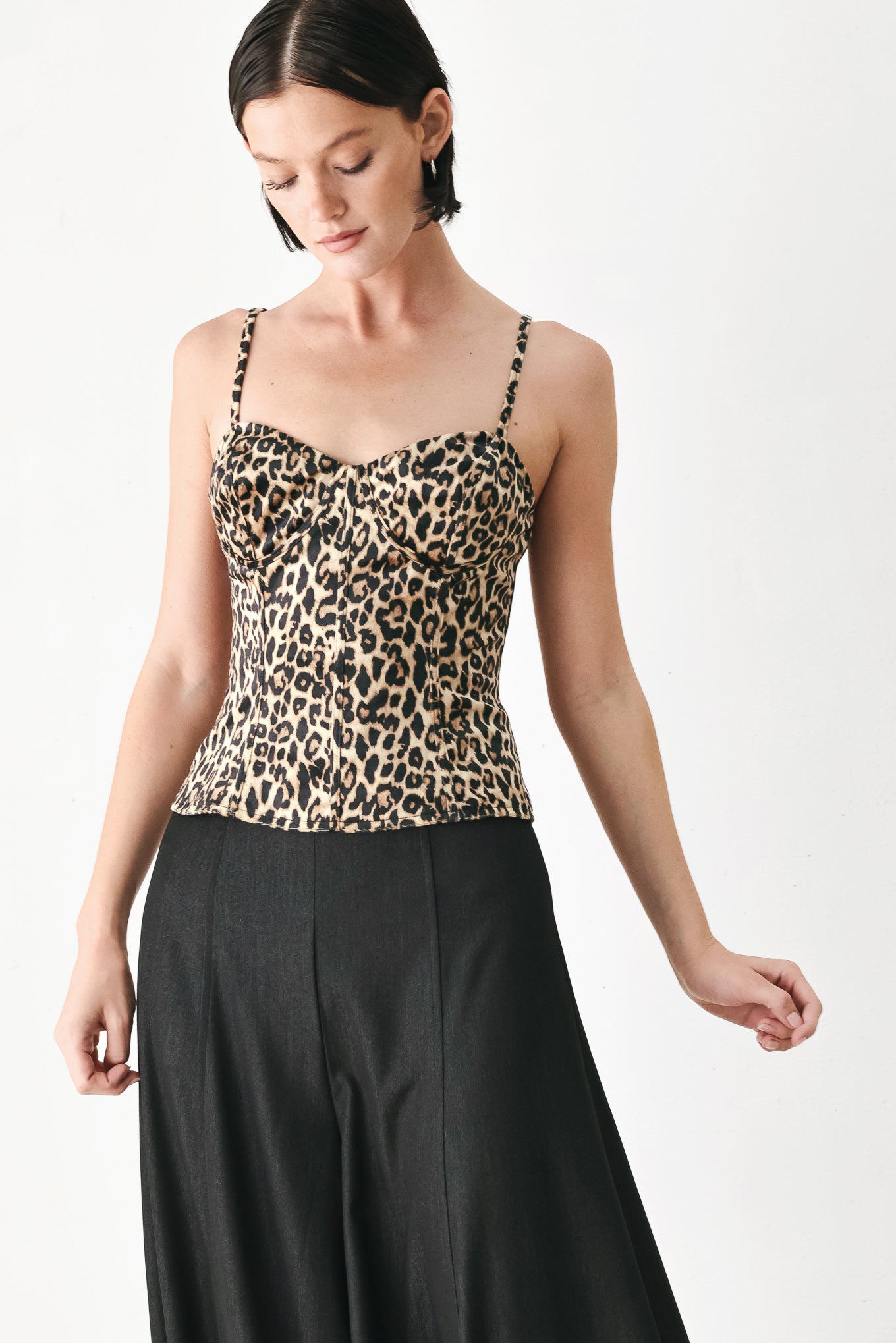 A woman modeling a leopard-print camisole top with thin straps and a structured corset-style bodice | FREEMARKET