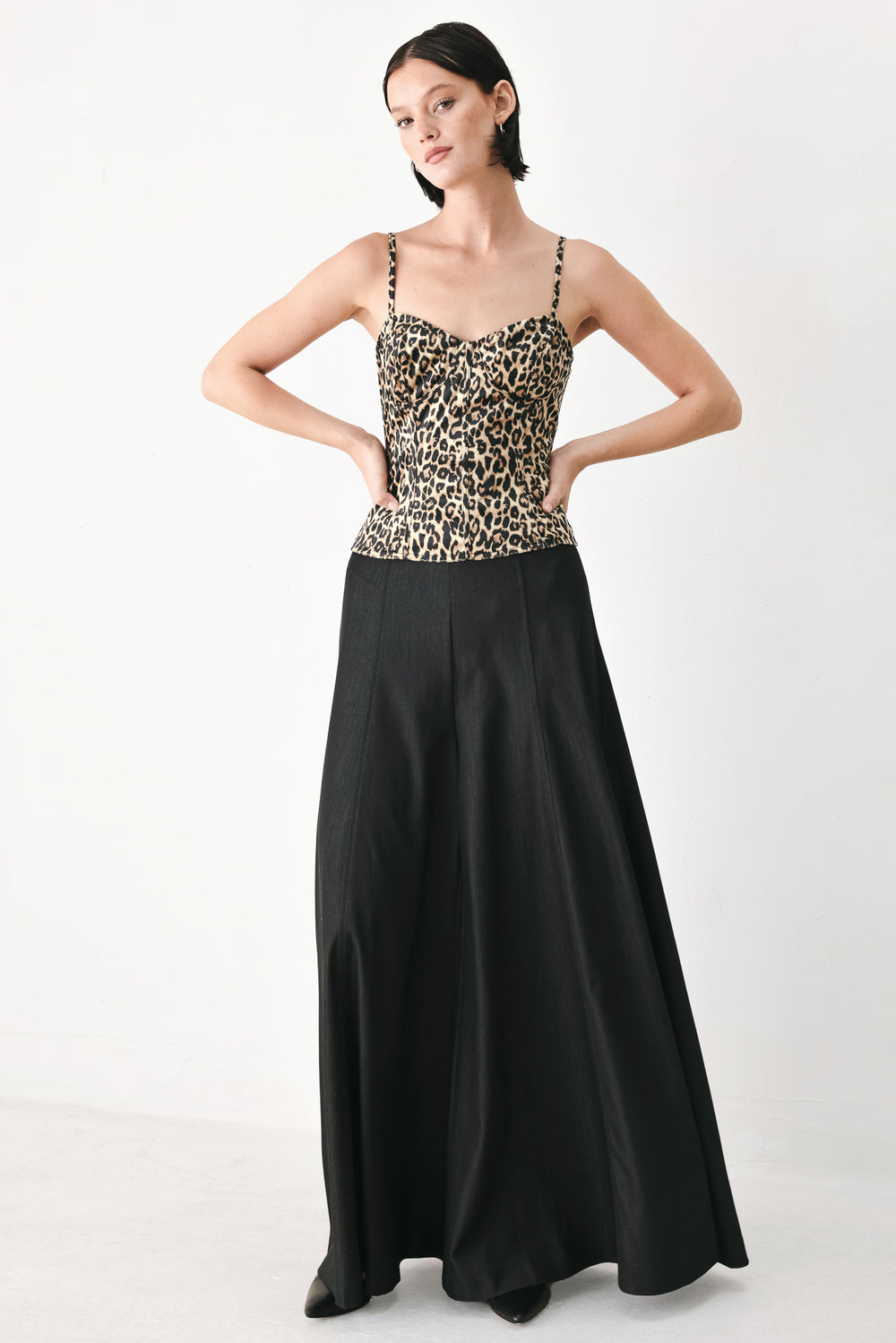 A woman modeling a leopard-print camisole top with thin straps and a structured corset-style bodice | FREEMARKET