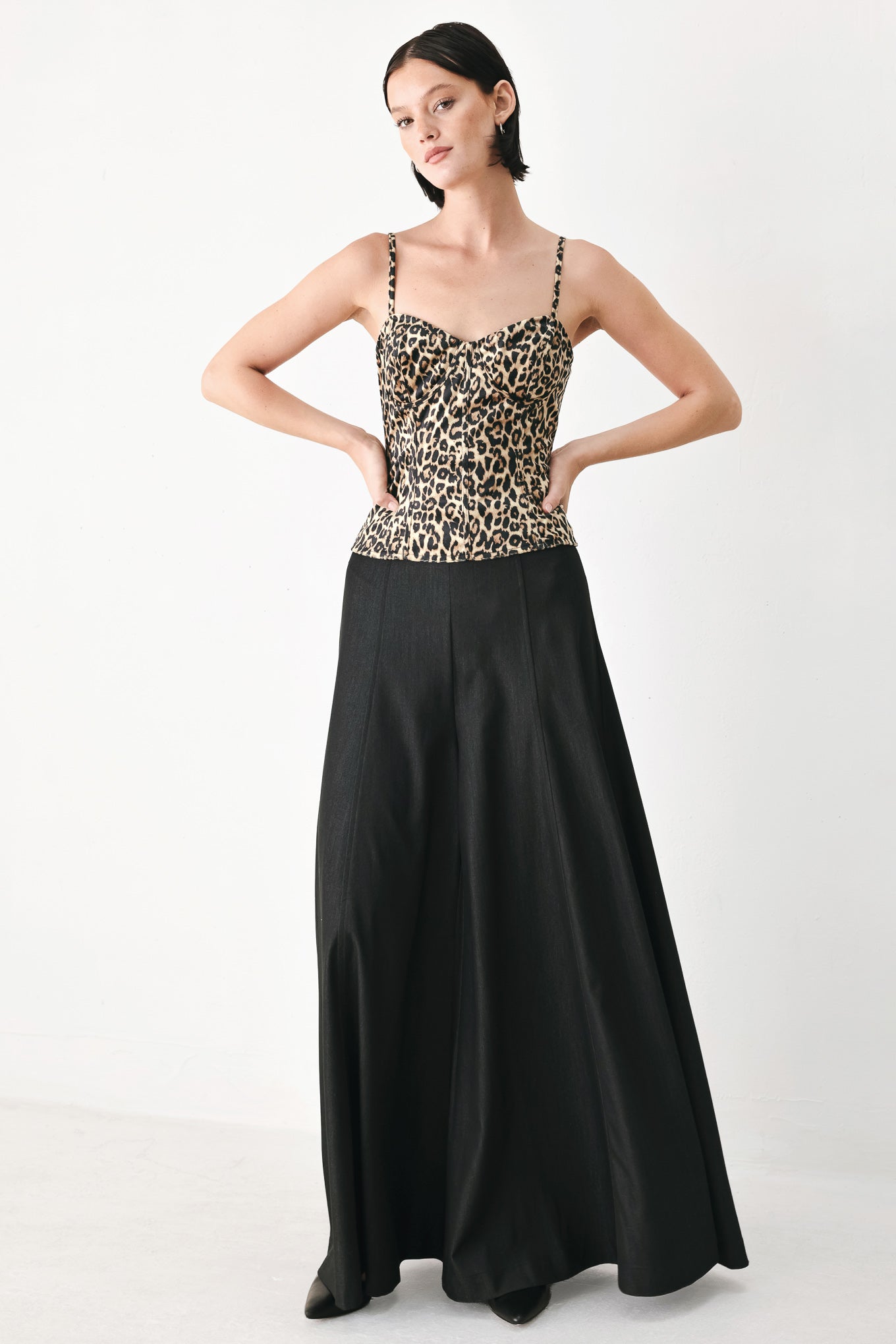 A woman modeling a leopard-print camisole top with thin straps and a structured corset-style bodice | FREEMARKET