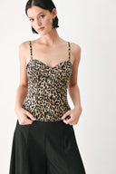 A woman modeling a leopard-print camisole top with thin straps and a structured corset-style bodice | FREEMARKET