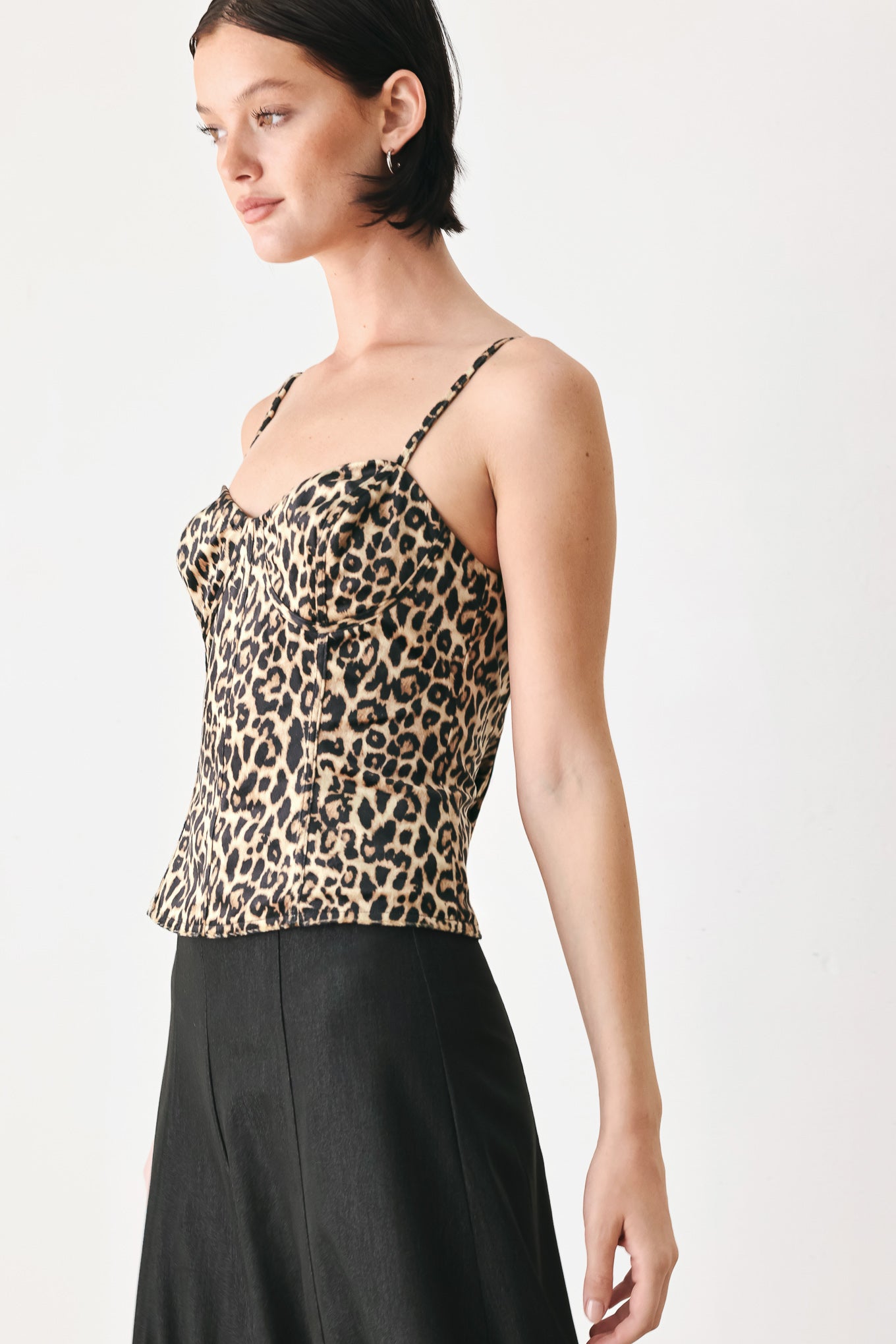 A woman modeling a leopard-print camisole top with thin straps and a structured corset-style bodice | FREEMARKET