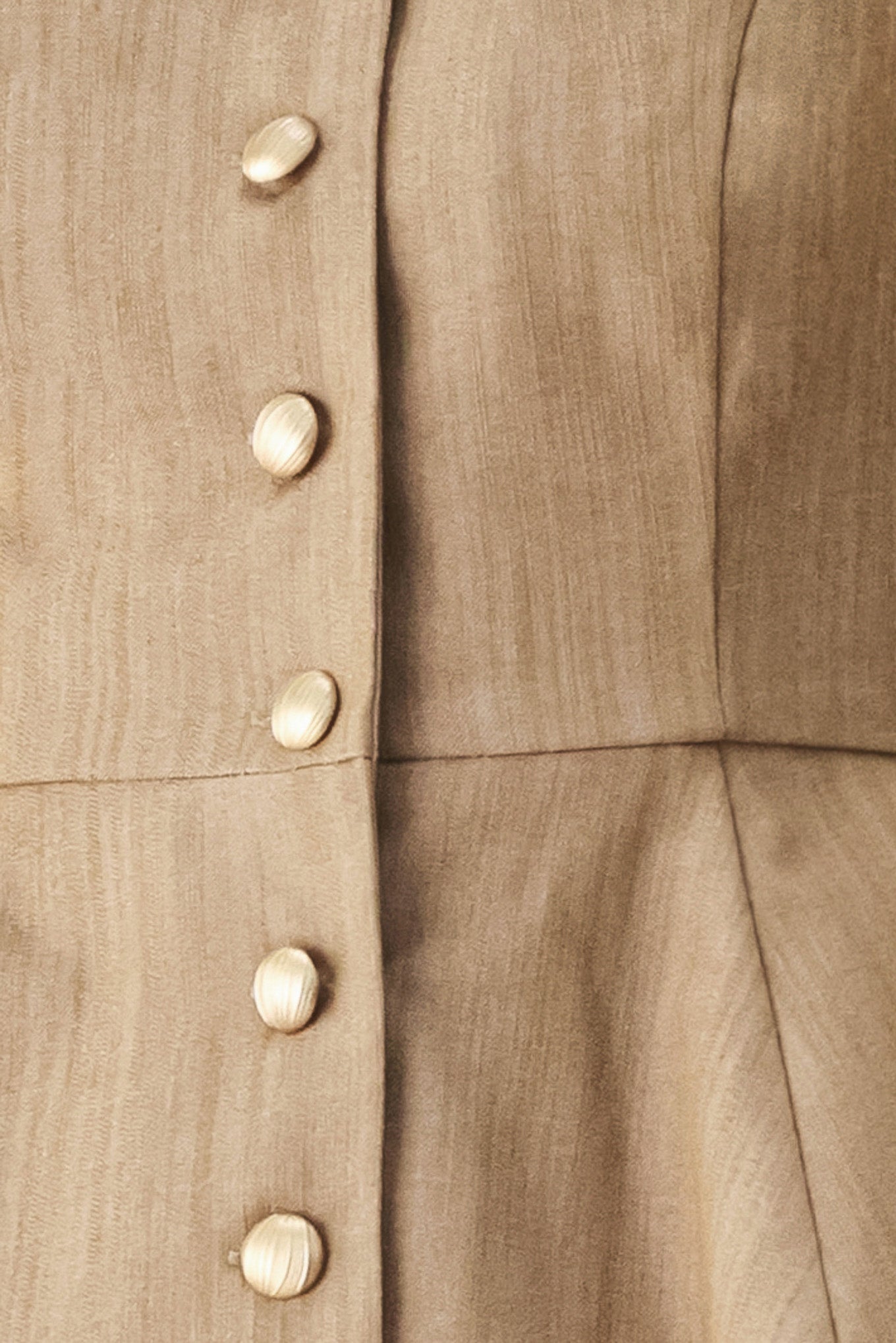 A woman wearing a tan linen camisole top with thin straps, a structured square neckline, peplum waist, and a front button closure | FREEMARKET