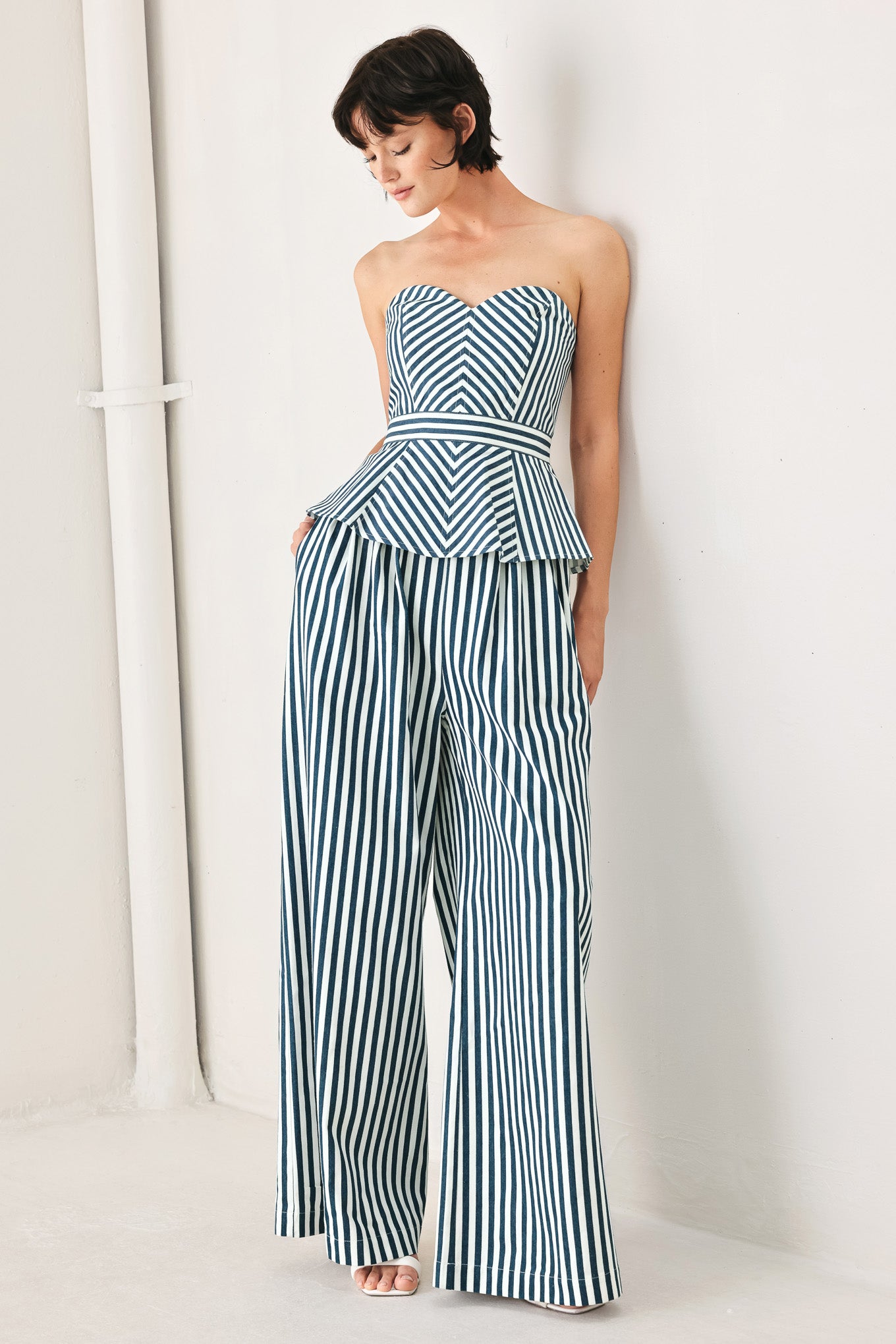 Woman wearing a strapless blue and white striped top | FREEMARKET