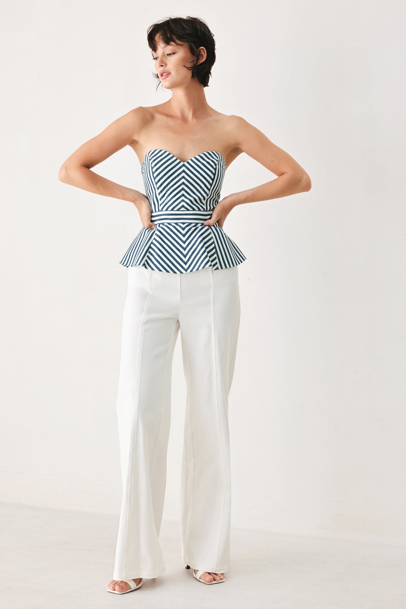 Woman wearing a strapless blue and white striped top | FREEMARKET