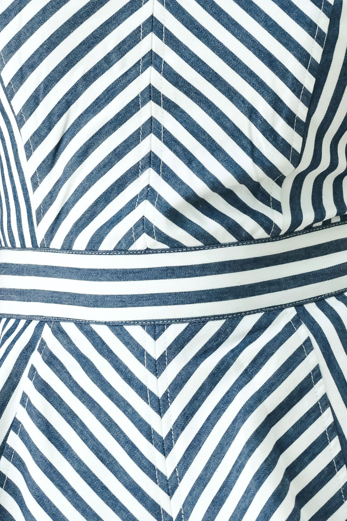 Close-up of a blue and white striped fabric with a chevron pattern.