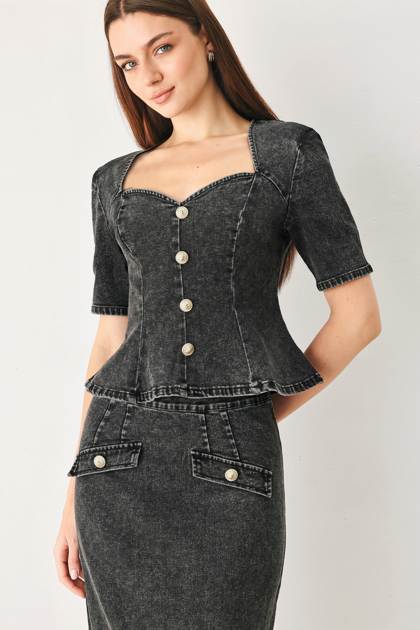 A denim top featuring sweetheart neckline, short sleeve, front button down and peplum. Matching skirt FK1316