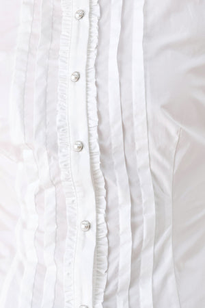 A woman wearing a white long-sleeve blouse with a high collar, decorative front pleats, and puffed shoulders | FREEMARKET