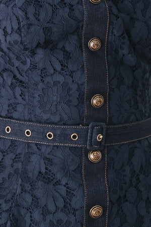 A woman wearing a strapless dark navy blue textured dress with a buttoned waist and a matching belt | FREEMARKET