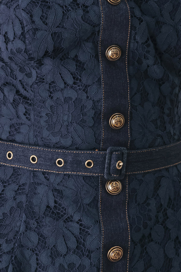 A woman wearing a strapless dark navy blue textured dress with a buttoned waist and a matching belt | FREEMARKET
