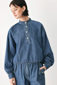 A model wearing a blue denim long-sleeve top with a buttoned mandarin collar | FREEMARKET
