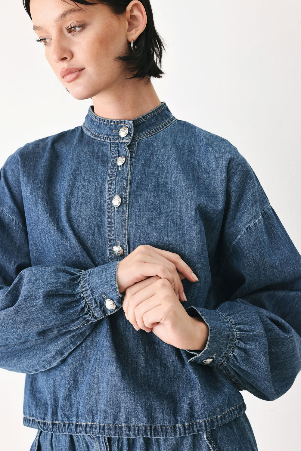 A model wearing a blue denim long-sleeve top with a buttoned mandarin collar | FREEMARKET