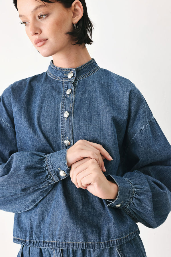 A model wearing a blue denim long-sleeve top with a buttoned mandarin collar | FREEMARKET