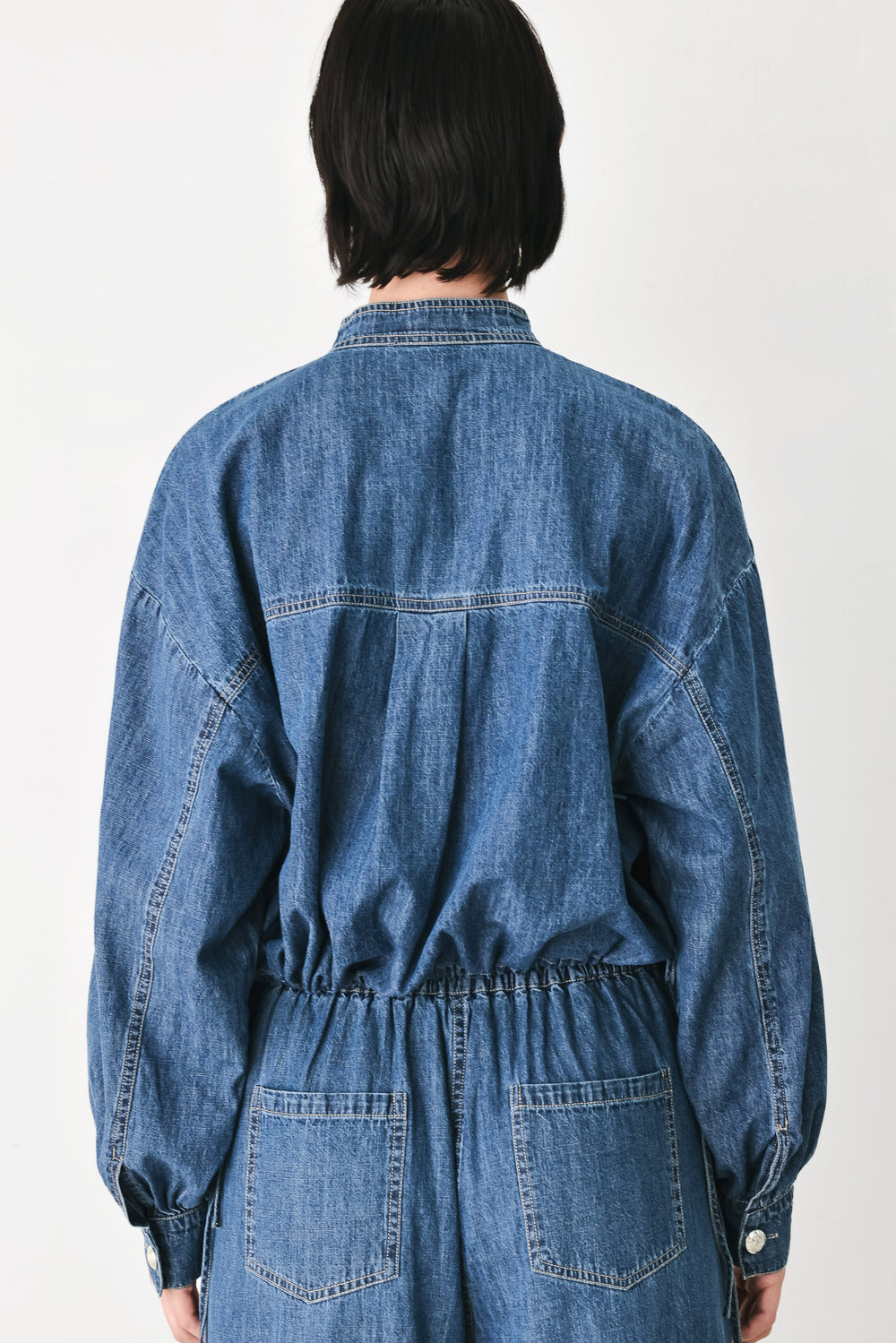 A model wearing a blue denim long-sleeve top with a buttoned mandarin collar | FREEMARKET