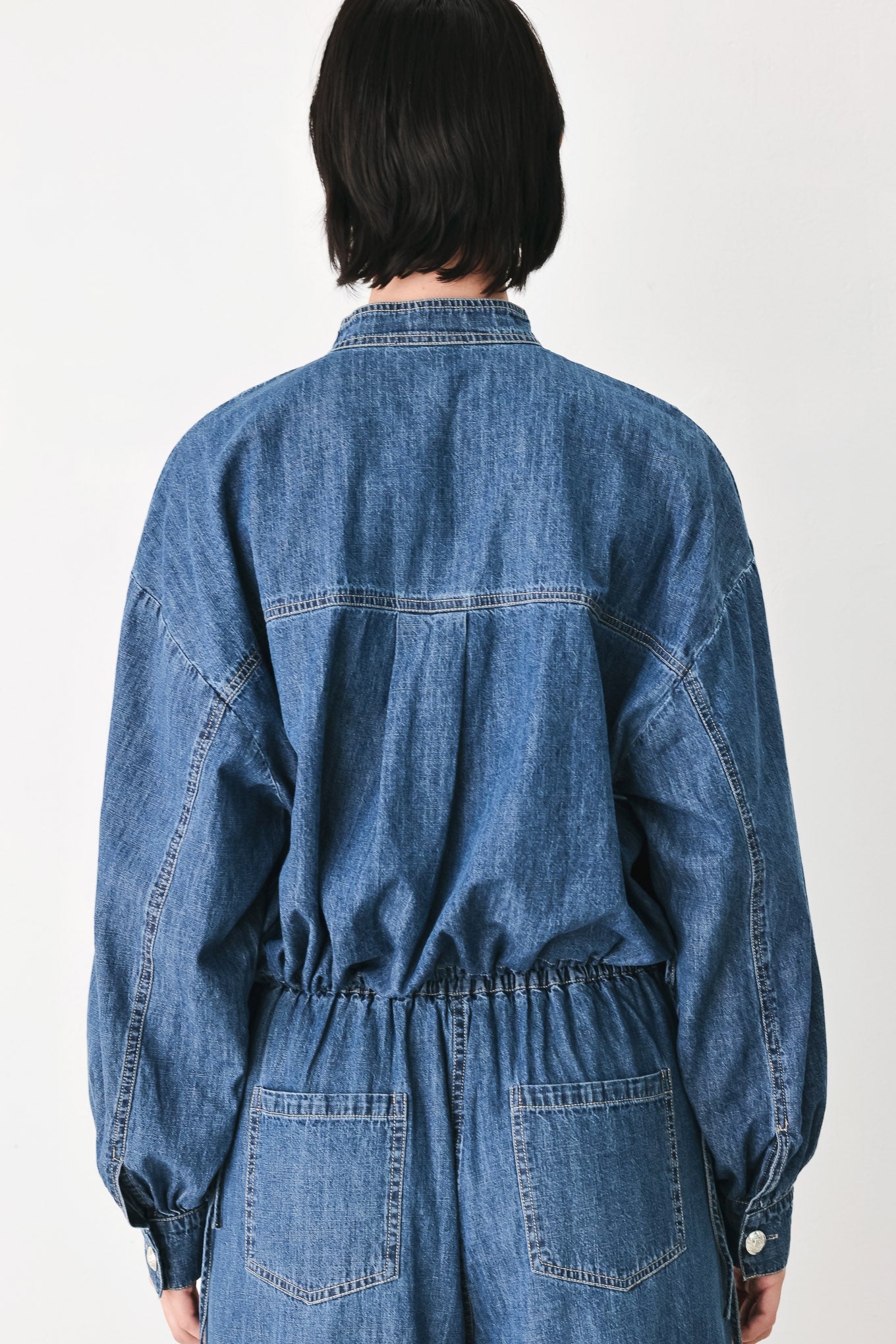 A model wearing a blue denim long-sleeve top with a buttoned mandarin collar | FREEMARKET