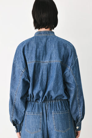 A model wearing a blue denim long-sleeve top with a buttoned mandarin collar | FREEMARKET