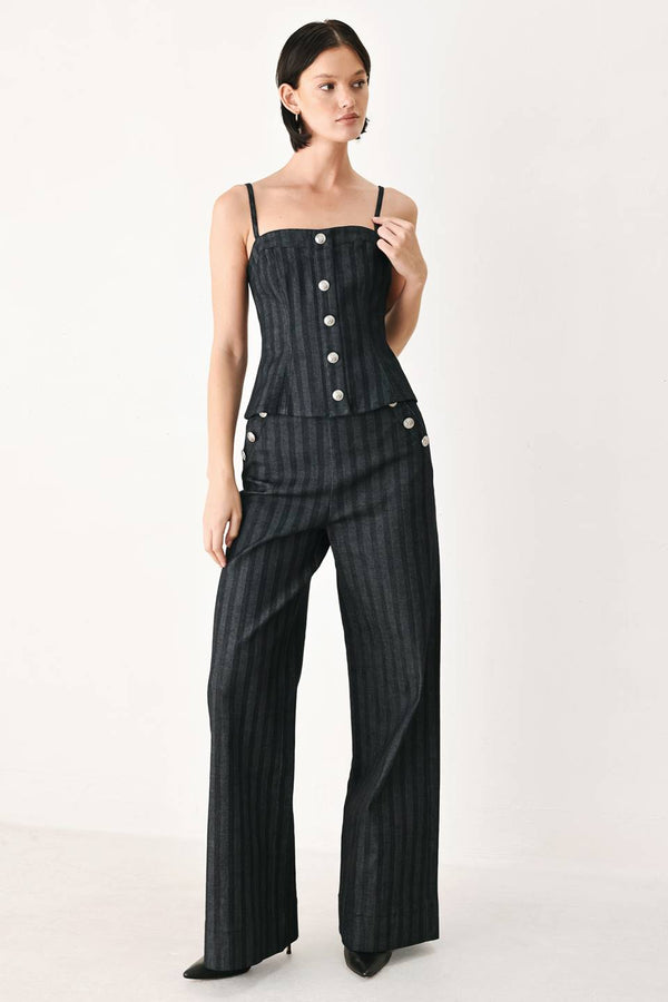 A model wearing a dark gray pinstriped jumpsuit with a structured corset-style bodice, thin shoulder straps, and prominent silver-tone decorative buttons down the front and on the waist | FREEMARKET