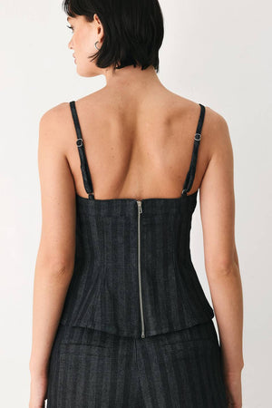 A model wearing a dark gray pinstriped jumpsuit with a structured corset-style bodice, thin shoulder straps, and prominent silver-tone decorative buttons down the front and on the waist | FREEMARKET