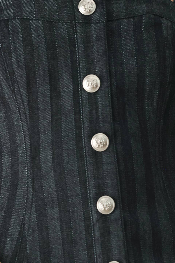 A model wearing a dark gray pinstriped jumpsuit with a structured corset-style bodice, thin shoulder straps, and prominent silver-tone decorative buttons down the front and on the waist | FREEMARKET