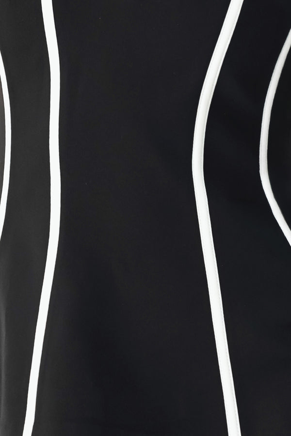 A woman wearing a strapless black corset-style top with bold white vertical stripes | FREEMARKET