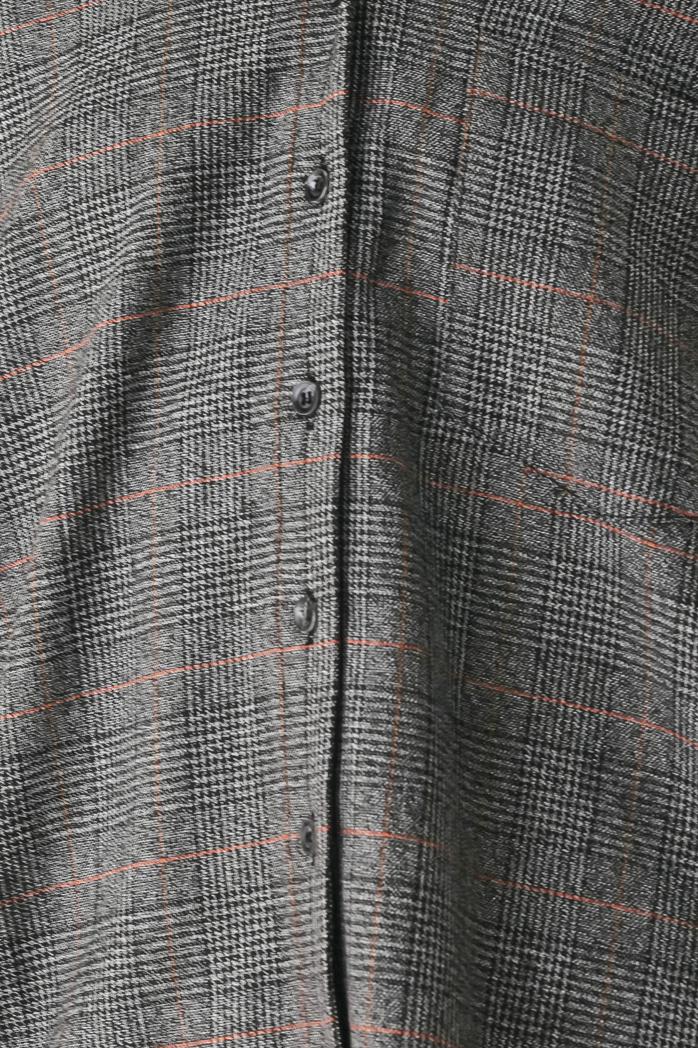 A model wearing a dark gray oversized button-up shirt with a subtle brown and orange windowpane plaid pattern | FREEMARKET