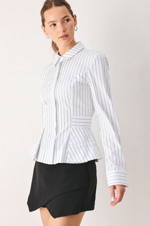 A woman wearing a white long-sleeve button-up shirt with thin vertical black stripes| FREEMARKET