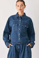 A woman wearing a dark blue denim button-up shirt jacket with two chest pockets | FREEMARKET