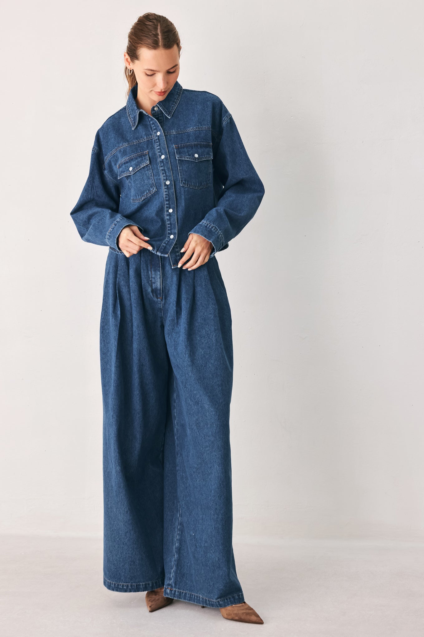 A woman wearing a dark blue denim button-up shirt jacket with two chest pockets | FREEMARKET