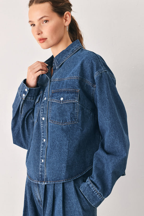 A woman wearing a dark blue denim button-up shirt jacket with two chest pockets | FREEMARKET