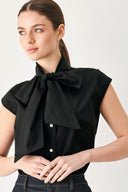 Woman wearing a black woven top with front bow tie and button down | FREEMARKET